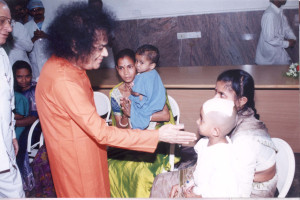 Swami Blessing a child after Neurosurgery